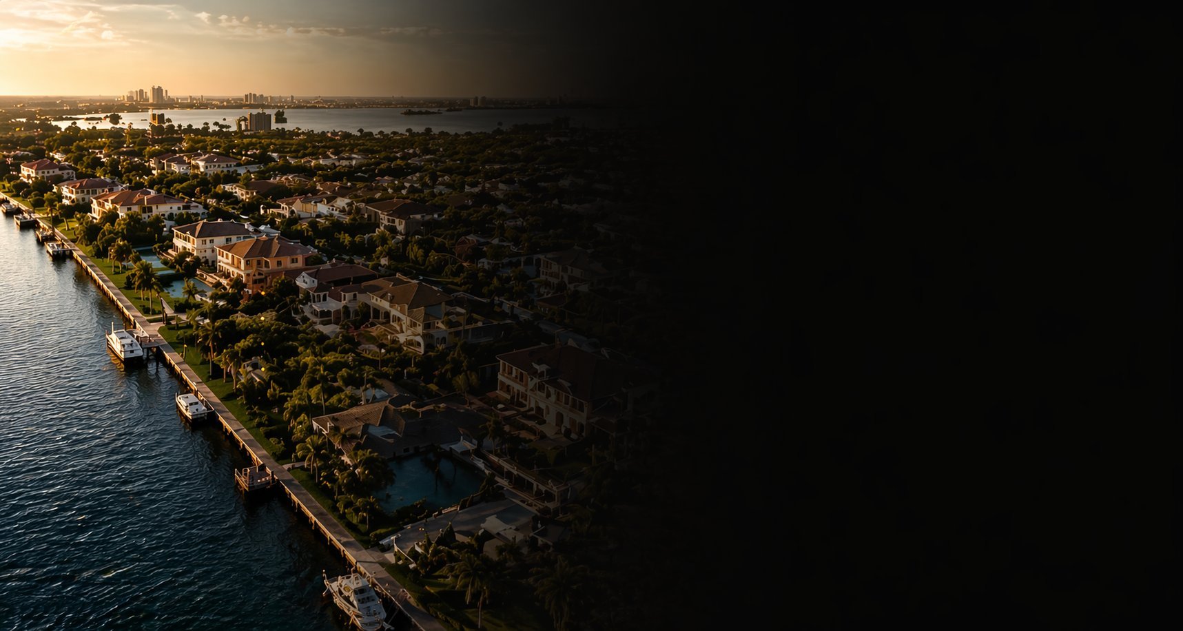 Aerial sunset view of a coastal city with dense buildings along a waterfront cliff overlooking the sea